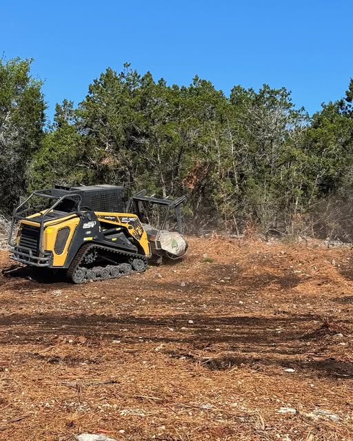 Forestry mulcher clearing brush and trees on ranch land